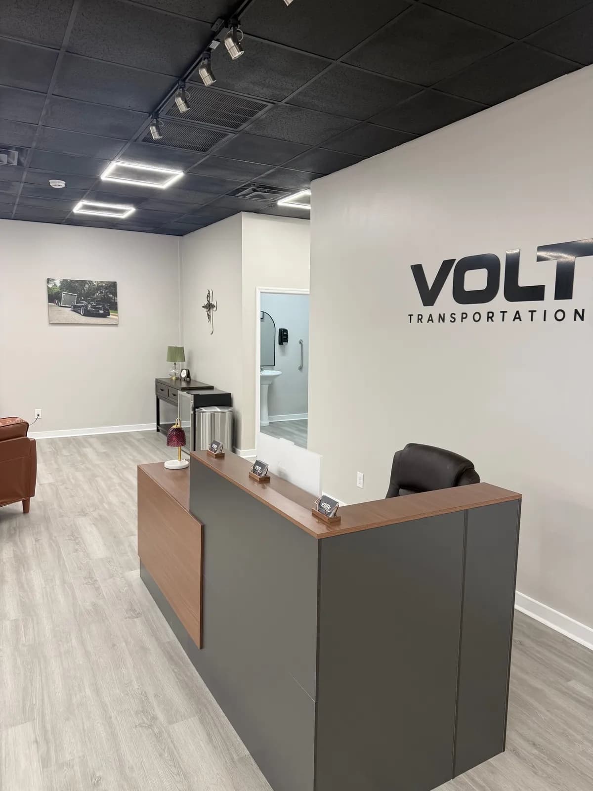 Volt Transportation front desk with the Volt sign on the wall
